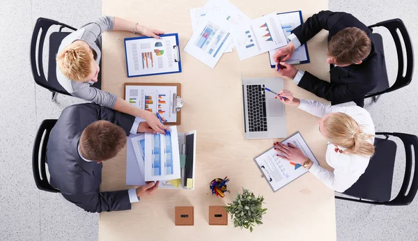 stock-photo-business-people-sitting-and-discussing-at-business-meeting-business-people